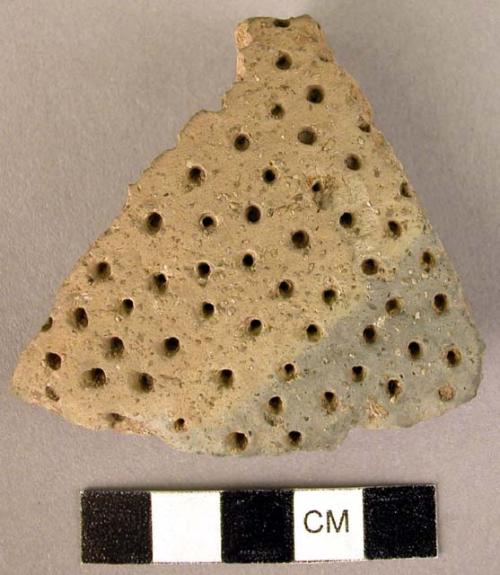 Sherd of collander of red hand smoothed ware