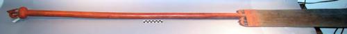 Wooden paddle, with zoomorphic carving. some red pigment. 82" overall. blade: 2