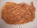 Lower part of cedar bark cradle filled with grass (shredded)
