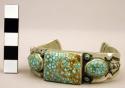 Silver cuff bracelet with stamped designs and inlaid turquoise stones