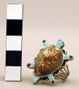 Silver turtle ring, back of turtle is cowrie shell, appendages are inlaid stone