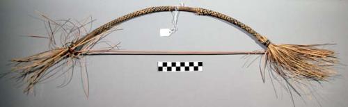 Bow used for ceremonial purposes in a dance, wound with checkered pattern straw