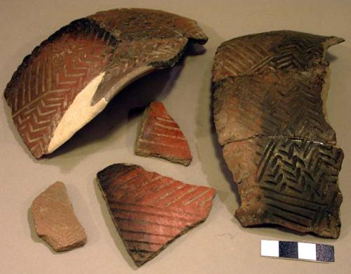 Ceramic rim and body sherds, incised, mended and reconstructed