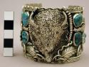 Wide cuff bracelet w/ buffalo head surrounded by turq. & silver flowers