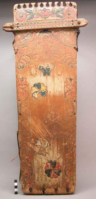 Painted and carved wooden cradle board