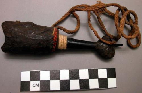 Small wooden whistle said to be worn about the neck to call others, especially