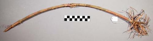 Bow used for ceremonial purposes in a dance, wound with checkered pattern straw