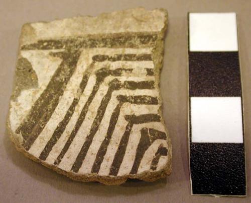 Ceramic body sherd, incised on one side, black on white linear, mended