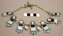 Doll necklace, silver chain with 7 inlaid doll figures & 2 sun symbols attached