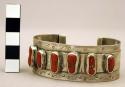 Cuff bracelet, flat silver band inlaid with coral nuggets, stamped designs