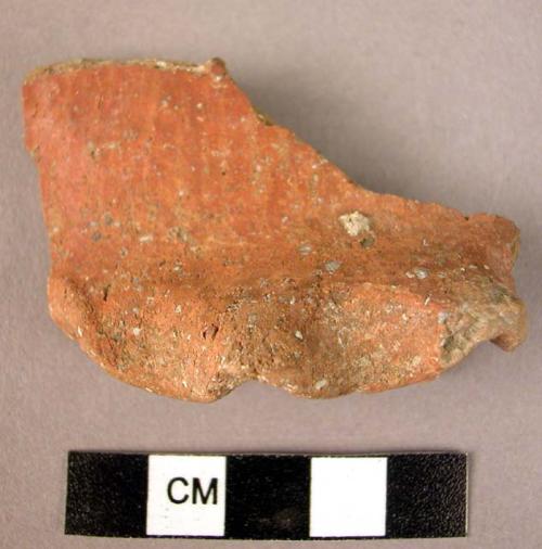 Red slipped burnished potsherd with folded ledge handle