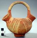 Double-spouted pottery pitcher - red painted decoration on buff