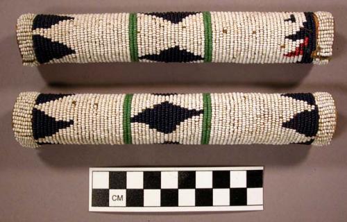 Hair ornaments. Rawhide tubes with multi-colored beadwork.