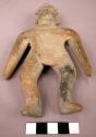 Flat clay figure.  Buff ceramic wth dark specks.  7 1/4" tall.