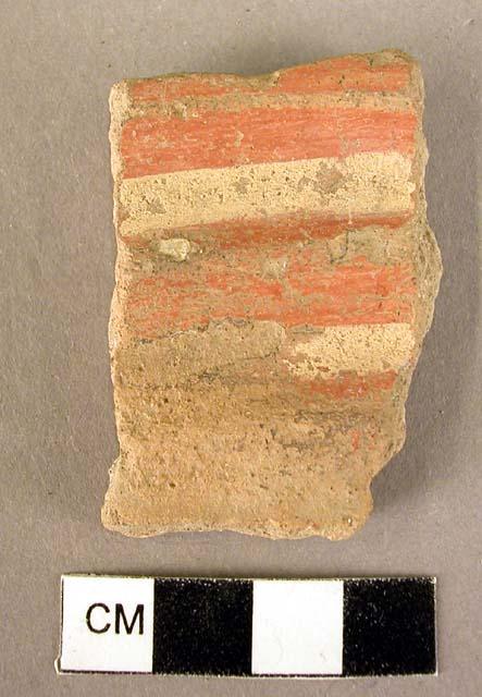 Potsherd [A]; fluted potsherd [B] - both are local red burnished ware. A is mere