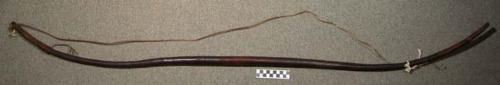 Wooden bow with leather cord. Wuta