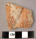 Ceramic body sherd, red ware with black painted linear design