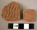 2 potsherds - red-brown, relief and incised