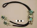 Bolo, silver ogre katsina with 4 turquoise stones set on a fan above the head