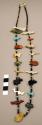 Necklace, 1 strand of tortoise shell & turq. heishi interspersed w/ fetishes