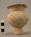 Red pottery vessel - pedestal base; restricted neck with flaring lip