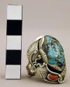 Silver ring, lg. central turq. stone w/ coral piece below, silver floral design