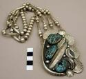 Silver, necklace, pendant w/ 3 turq. stones, fan-& feather shaped designs