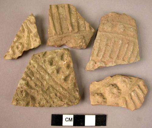 5 potsherds - light colored, moulded