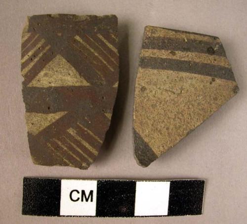 Ceramic rim sherd with black designs on exterior