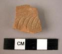 Potsherd - red-brown, relief and incised