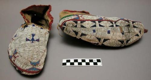 Pair of red, white and blue beaded leather moccasins