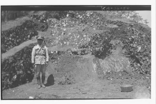 Man in front of southeast corner of structure 7, mound A