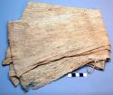 Bark cloth, brown, folded.