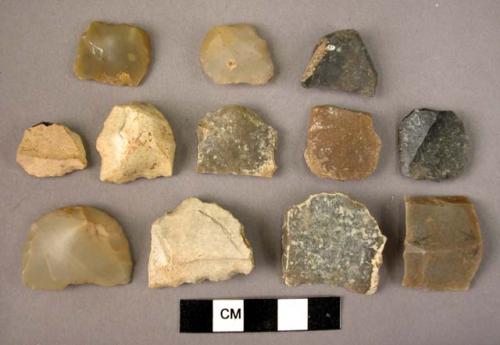 12 flint pieces like gun flints, showing abrupt retouch