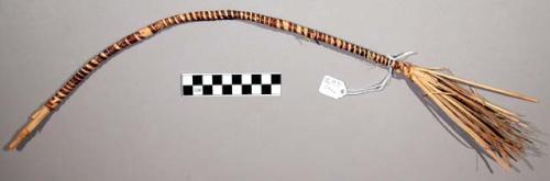 Bow used for ceremonial purposes in a dance, strips of grass held in place by sm