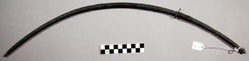 Small wooden bow wound with thin strip of metal, fibre bow string (tiba)
