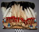 War bonnet. Made of buckskin. Beaded band with 'mountain' and 'star' designs.