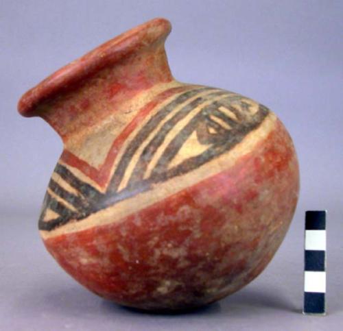 Pottery jar, red base with black and red ornament on upper yellow zone