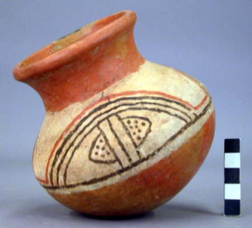 Pottery jar, red base with black and red ornament on upper yellow zone