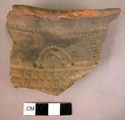 Red-brown potsherd - wide lip, involved stamped & incised pattern