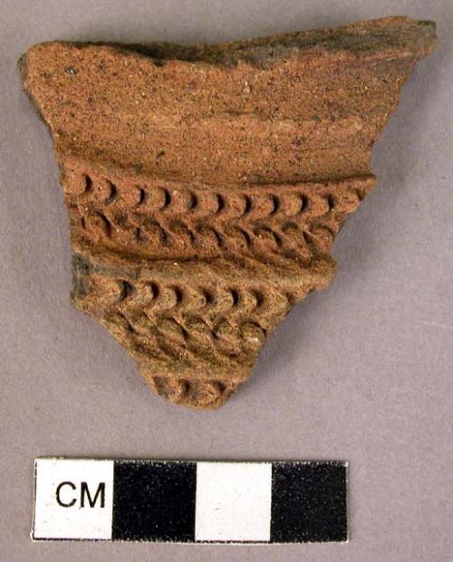 Red ware sherd - involved stamped or rolled pattern