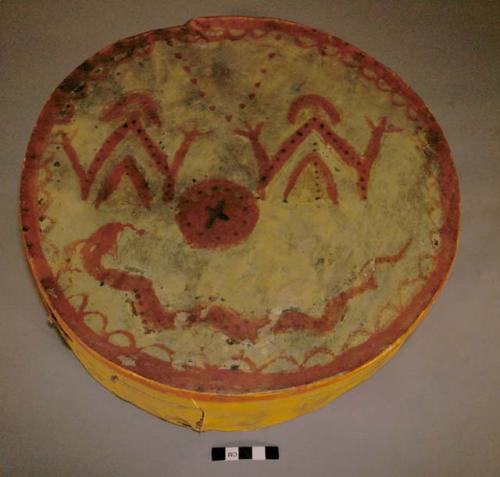 Cheese box drum, probably Plains. Rawhide over cheese box frame. Painted designs