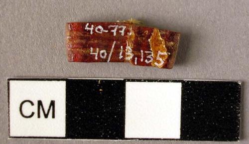 Rectangular amber spacer, decorated on one side with two grooves