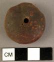 Disk-shaped amber pendant, cross-drilled