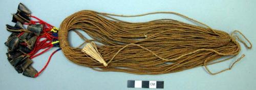 Belt of cords with beads and bone (?) tassels behind - ceremonial