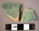 Ceramic rim and body sherd, irridescent blueish-green glaze