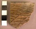 Ceramic rim sherd, incised, redware, burnt interior