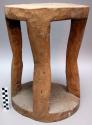 Stool, carved wood, round seat & base w/4 cutout legs, cracked