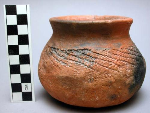 Small round pottery vessel.