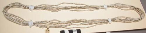 Reed arrow with metal blade; necklace of white glass beads - 7/7/77 - V.H.